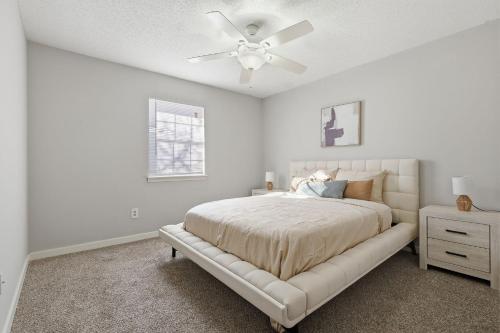 a white bedroom with a bed and a ceiling fan at Comfortable 2BR2BA with Modern Touches in Jackson