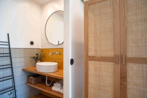 a bathroom with a shower with a sink and a mirror at Villa dos Corcéis in Esposende