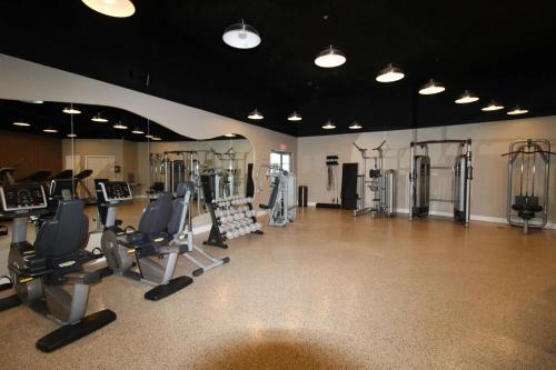 a gym with several treadmills and exercise machines at Castle B6 in Miami Beach