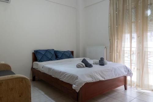 a bedroom with a bed with two stuffed animals on it at Philoxenia Studio Larissa in Larisa