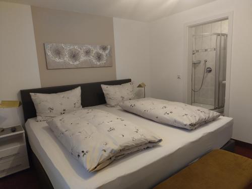 a bed with two pillows on it in a room at Ferienhaus am Sonnenhang in Willingen