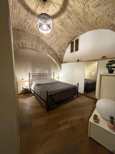 a bedroom with a bed and a brick ceiling at Vicolo San rufino in Assisi