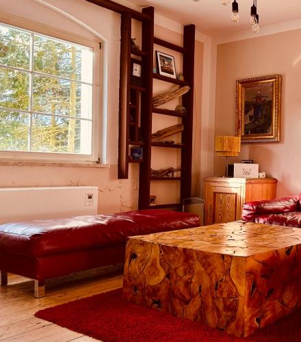 a living room with a tree stump coffee table at Gemütliches Haus im grünen in NFO in Niederfinow