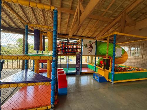 a childrens play room with multiple play equipment at Montinni Hotel in Socorro