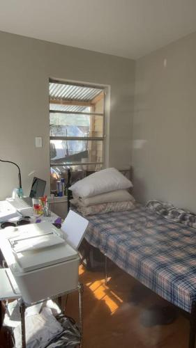 a room with a bed and a desk and a desk at Only 25 dollars-Man's bed in a room in Texas City