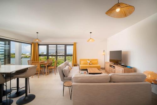 a living room with a couch and a table at Laena Lodge in Papeete