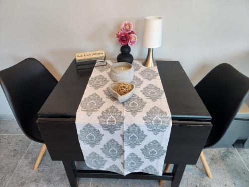 a table with a table cloth on it with two chairs at Pamir in Ferdinandshof