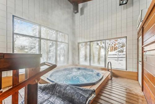 a jacuzzi tub in a room with two windows at Keystone Retreat with Resort Amenities in Keystone