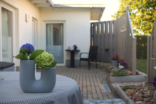 a table with a vase with flowers on it at Ferienwohnung Borken in Bad Salzungen