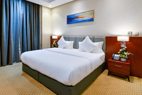 a bedroom with a large bed with white sheets at Best Day Hotel and Resorts المحمدية in Jeddah
