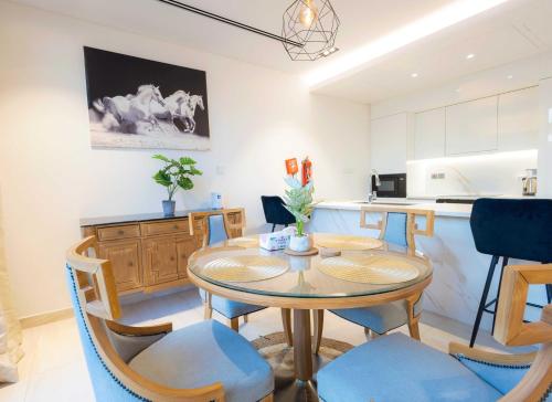 a kitchen and dining room with a table and chairs at Danah Bay Beachside Private Villa in Ras al Khaimah