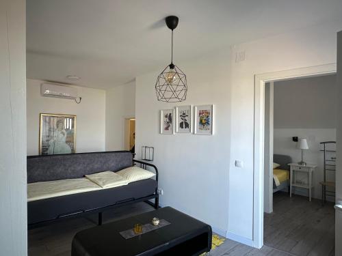 a living room with a bed and a table at Košava in Golubac