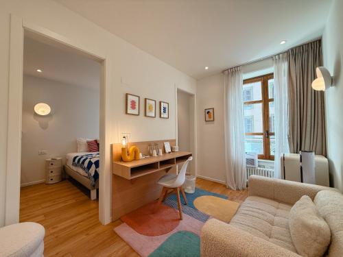 a bedroom with a bed and a desk in a room at Rhodania Boutique Hôtel in Geneva