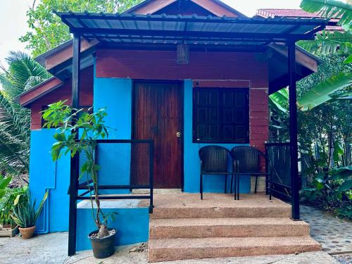 a small house with a blue and red exterior at Hayar House's Cabin house at kantiang bay in Ko Lanta