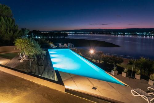 a swimming pool on a house with a view of the water at PUEBLO CHICO - casas de lago in Villa Ciudad de América