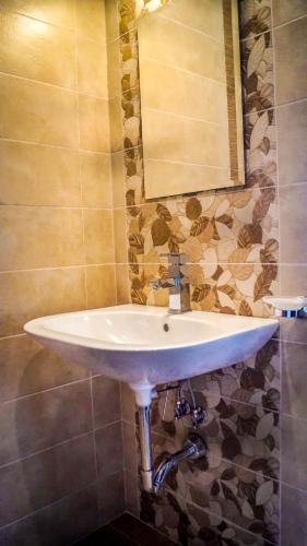 a white sink in a bathroom with a mirror at Guest House Meridi in Preseltsi