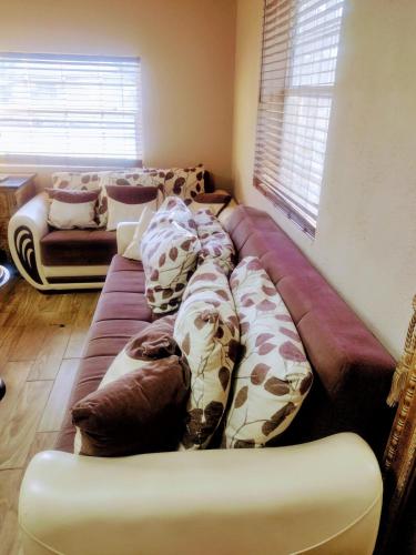 a long couch with pillows on it in a living room at A great environment living space in Orlando