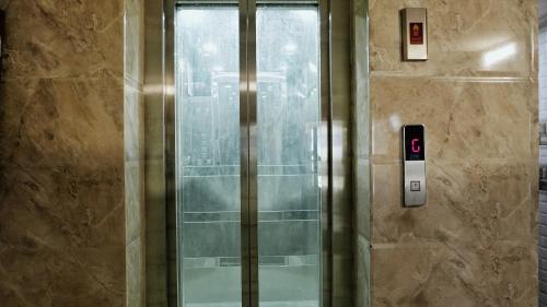 a shower with a glass door in a bathroom at Ashu Villa in New Delhi