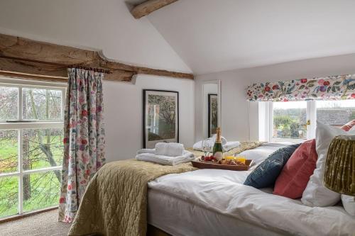 a living room with a white couch and windows at Hop Pickers Cottage in Little Marcle