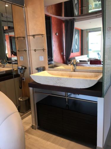 a bathroom with a large sink in a room at Elixxir in Cap d'Agde