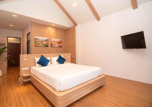 a bedroom with a bed and a flat screen tv at The Poom Cafe & Resort Khao Yai in Ban Khanong Phra Klang (1)