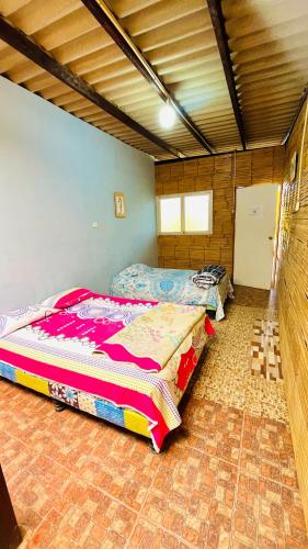 a bedroom with two beds in a room at Arrullos del Mar in Zorritos