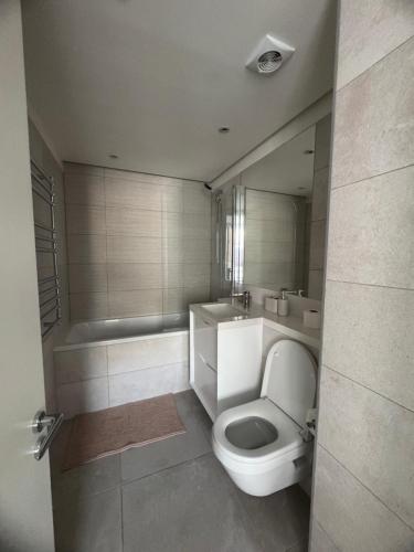 a bathroom with a toilet and a sink and a tub at VV - Skyline Studio Pool & Gym in City Centre in Gibraltar