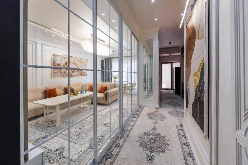 a hallway with glass walls and a living room at Toshkent city apartments in Tashkent