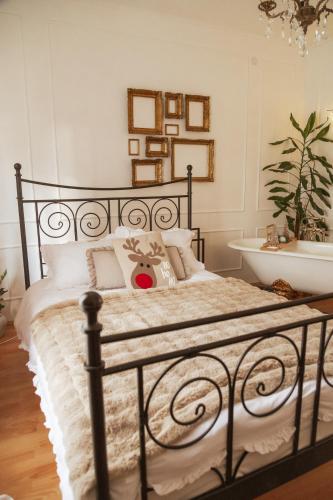 a bedroom with a black bed and a sink at Chic&Vrdnik in Vrdnik