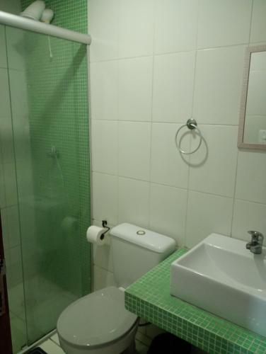 a bathroom with a shower and a toilet and a sink at Suíte casal Bela Vista 207 in São Paulo