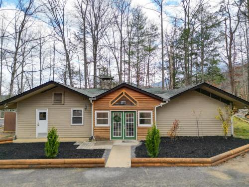 a house with a green door in a yard at Shady Woods Cabin in Gatlinburg