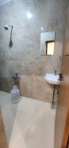 a bathroom with a sink and a shower at SRI KRISHNA LODGE in Hosūr