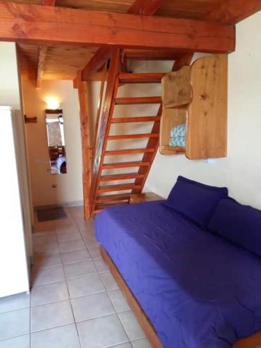 a bedroom with a bed and a wooden staircase at Duplex lo de Aaron in El Bolsón