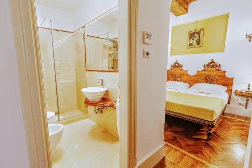a bedroom with a bed and a shower and a sink at Arpinelli Suite in Rome