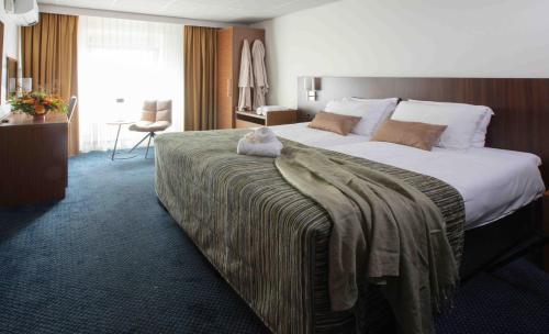 Giường trong phòng chung tại Hampshire Hotel Petit Nord