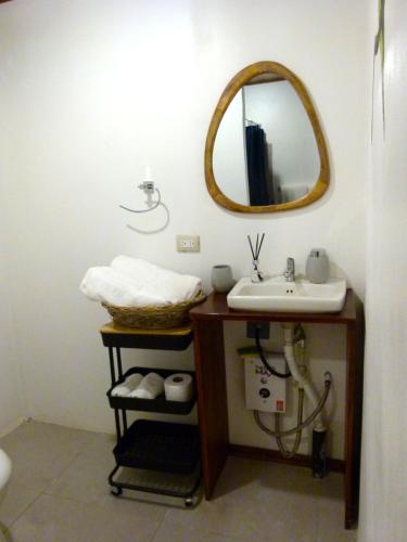a bathroom with a sink and a mirror at Primer Canto B&B - Near Ferry & Early Birdwatching Trails in Lepanto