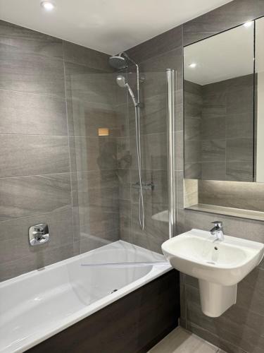 a bathroom with a tub and a sink and a shower at Chalk in Moffat