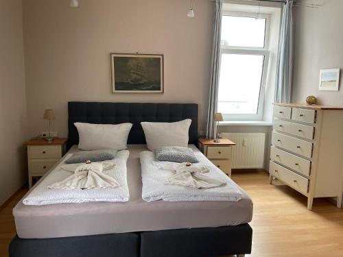 a bedroom with a bed with towels on it at Fürstenhof Sassnitz in Sassnitz