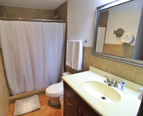 a bathroom with a sink and a toilet and a mirror at Suite Esteli 114 Gran Pacifica Resort in San Diego