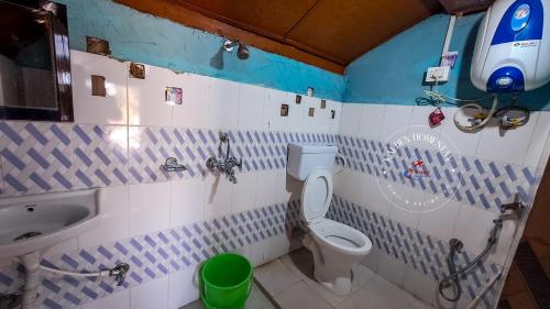 a bathroom with a toilet and a sink at Kalden Homestay Sinji in Kalimpong
