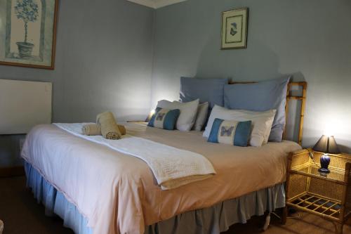 a bedroom with a large bed with white sheets and pillows at Dunford's Loft in Himeville