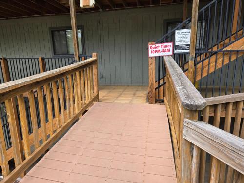 a sign on a wooden bridge with a sign on it at Swan's Woodland Getaway Condo in Reeds Spring