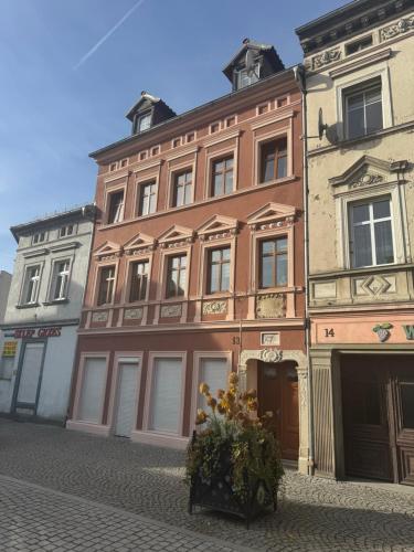 a large brick building with a plant in front of it at Fly Adventures- dom wędkarza in Leśna