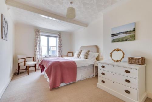 a white bedroom with a bed and a dresser at 3 Bed in Woodbridge oc-tst in Melton