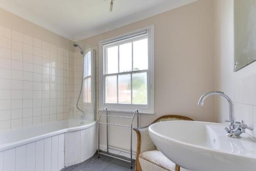 a white bathroom with a tub and a sink at 3 Bed in Woodbridge oc-tst in Melton