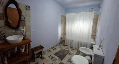 a bathroom with two toilets and a sink at Cabaña Rincón de Afrodita in San Lorenzo