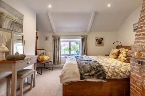 a bedroom with a bed and a desk and a window at 2 Bed in Heacham oc-2013 in Heacham