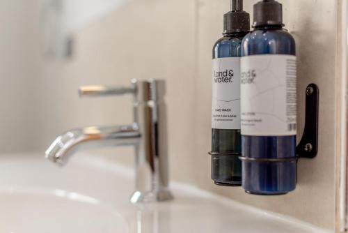 a bathroom sink with a bottle of water next to a faucet at 6 Bed in Winnards Perch oc-t29966 in Saint Columb Major