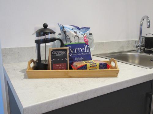 a tray of food sitting on a counter next to a sink at Evening Star Cottages in Saundersfoot