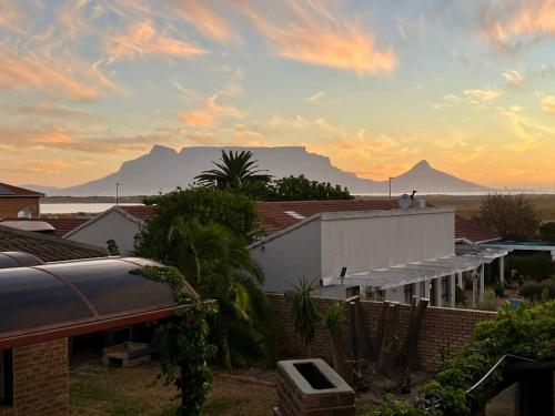 a view of a house with a mountain in the background at Egret's Lookout in Cape Town